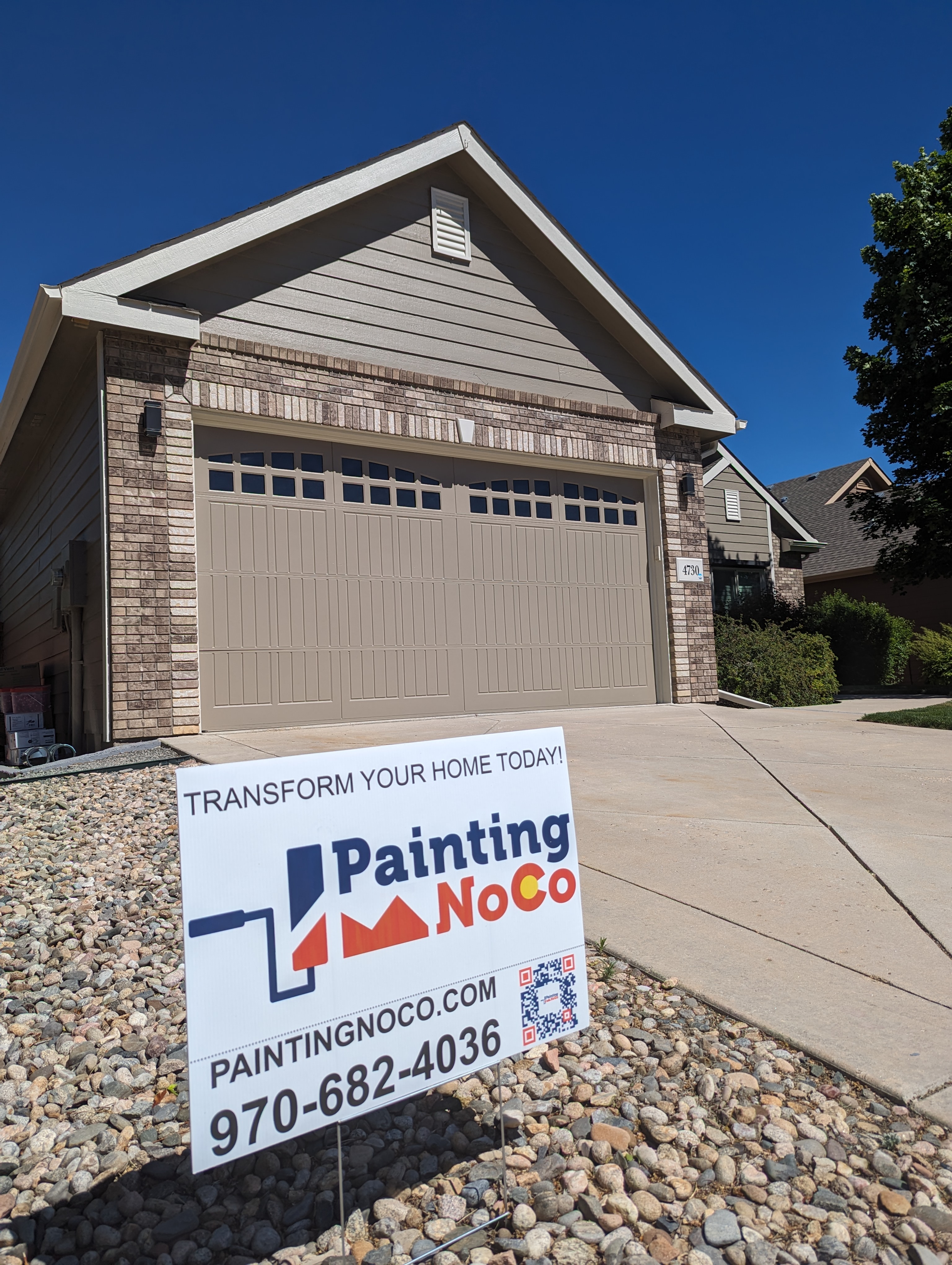 Picture showing Painting NoCo yard sign in front of a freshly painted exterior.